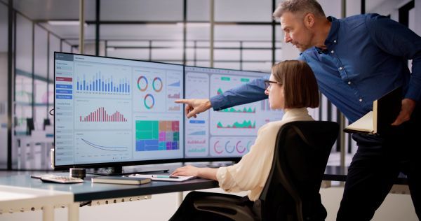 Two researchers discussing through graphs