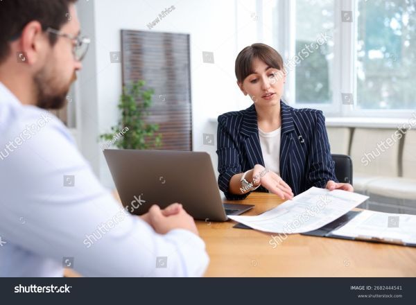 A woman showing documents to a man